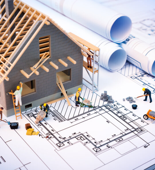 building house on blueprints with worker - construction project building house on blueprints with worker - construction project